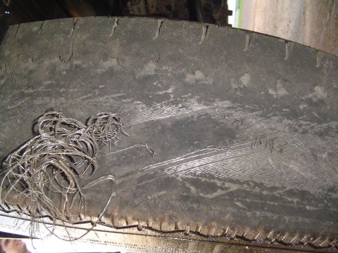 2000 Chevrolet Tahoe - A close-up view shows tangled wires and significant wear on a vehicle's tire.