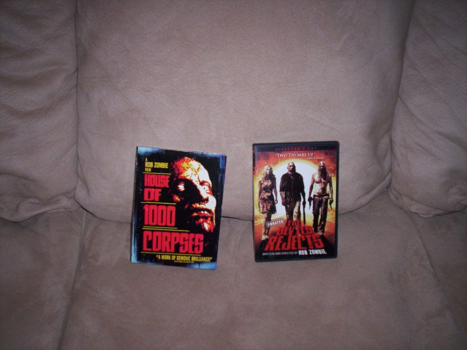 Two movie cases, House of 1000 Corpses and The Devil's Rejects, on a couch