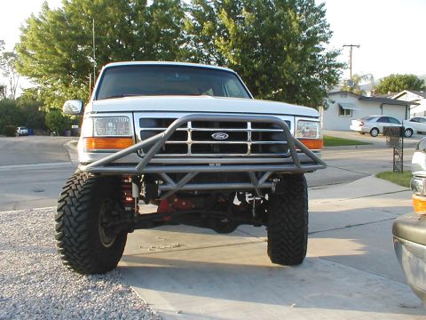 1996 Ford Bronco - Front view of a 1996 Ford Bronco a custom-built metal brush guard over the grille and bumper.