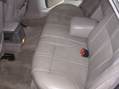 1995 Ford Taurus - Interior view of a car's rear seating area, showing the bench seat and center console.