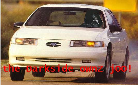 White 1992 Ford Taurus, front view, with red text overlay "the Darkside ownz joo!" and Supermotors logo