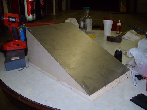 2004 Ford Crown Victoria - A partially constructed ramp made of wood and metal sits on a table with various tools and supplies.
