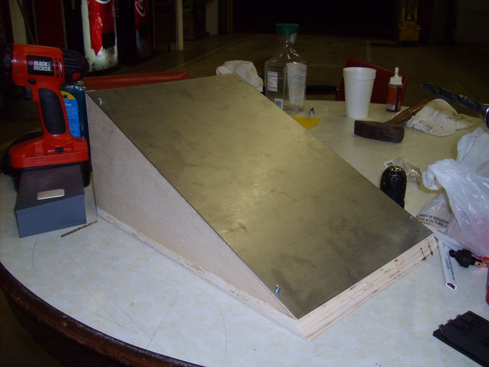 Wooden ramp with metal top being built, next to a drill and tools