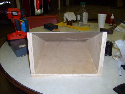 2004 Ford Crown Victoria - A wooden box sits on a table, surrounded by various tools and bottles, including a Black & Decker drill.