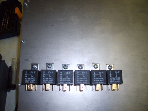 2004 Ford Crown Victoria - Automotive relays with visible text indicating their specifications.