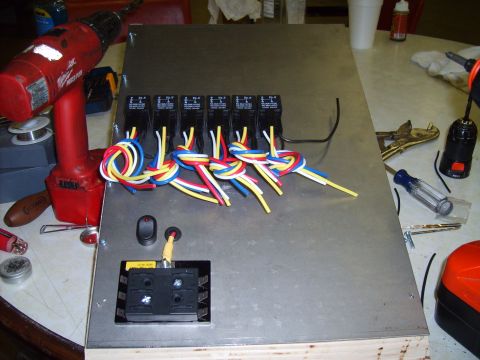 2004 Ford Crown Victoria - A custom wiring harness with multiple relays and a fuse block is laid out on a metal panel, with tools nearby.