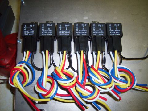 2004 Ford Crown Victoria - Close-up of automotive relays and their associated wiring harness.