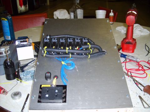 2004 Ford Crown Victoria - Custom wiring panel with electrical components and tools laid out on a table.