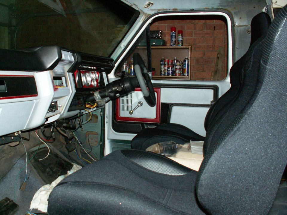 Bucket seats from e-bay, dash and trim recolour from rattle can, steering wheel and column hub from local auto parts store....will look great once carpet and B & M floor shifter is installed.