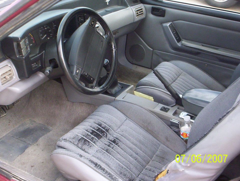 Gray cloth interior of a Fox-body Ford Mustang driver area