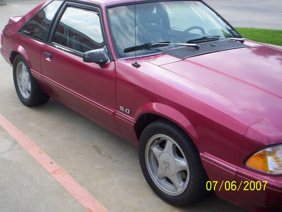 Pink-red Fox body Mustang hatchback with 5.0 badge and Pony wheels, passenger side view, dated 07/06/2007