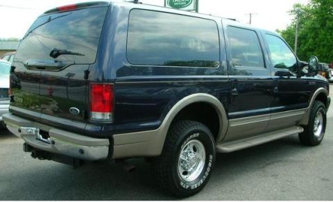 2000 Ford Excursion - This 2000 Ford Excursion SUV is seen from the rear 3/4 angle, revealing its two-tone paint scheme and side profile.
