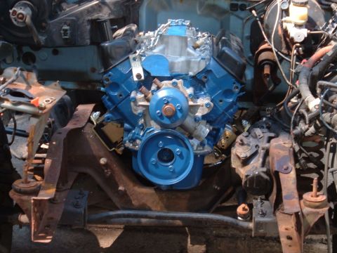 1990 Ford Ranger - Engine bay view showing a blue painted engine with various hoses and components.