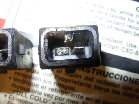 1995 Ford Taurus - An electrical connector is shown in close-up, with some text visible on the document beneath it.