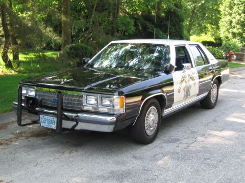 1991 Ford Crown Victoria - 1991 Ford Crown Victoria police car, marked "HIGHWAY PATROL", parked on a paved surface.