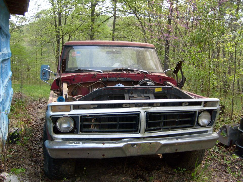 Red 1976 Ford F-100 front view, hood open, showing engine bay