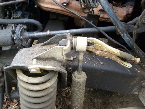 1976 Ford F-100 - Close-up of an engine bay part secured with vice grips, showing suspension components.