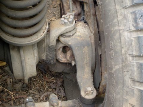 1976 Ford F-100 - The image shows a detailed view of a vehicle's suspension system, including a coil spring and control arm.