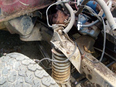 1976 Ford F-100 - Close-up view of engine and suspension components, with visible rust and wear.