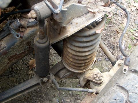 1976 Ford F-100 - This image shows a close-up of a rusty engine swap part, with a SuperMotors logo visible at the bottom.