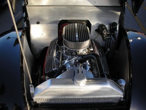 1998 Ford Crown Victoria - The engine bay of a classic car showcases a polished V8 engine with chrome accents and an exposed air filter.