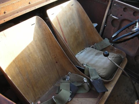 1998 Ford Crown Victoria - The interior features custom wooden bucket seats with racing harnesses and a prominent floor shifter, suggesting a modified vehicle.