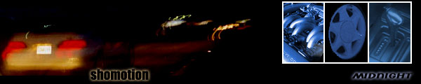 Yellow car rear view at night, with red taillights and a white license plate