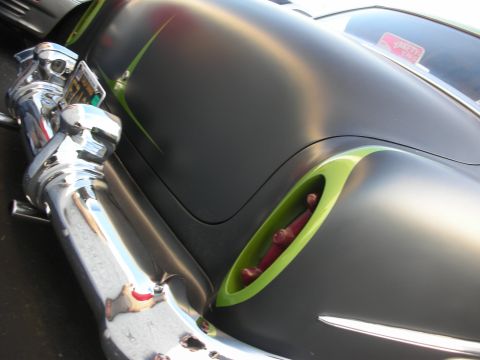 1998 Ford Crown Victoria - A customized car with a matte gray finish and bright green trim is shown from the rear quarter panel.