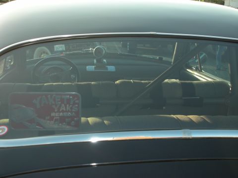 1998 Ford Crown Victoria - Interior view of a car with a roll cage and a 'Yakety Yaks' sticker on the rear window.