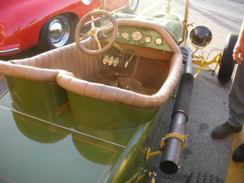 1998 Ford Crown Victoria - Close-up of a vintage car's interior, showing the steering wheel, pedals, and dashboard gauges.