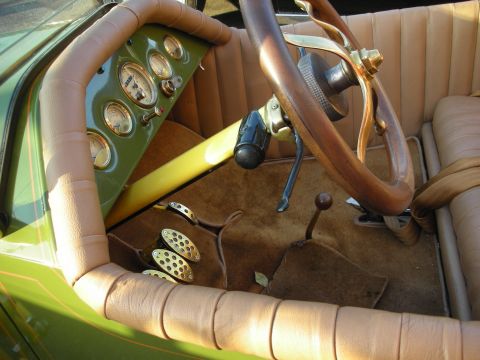 1998 Ford Crown Victoria - The interior of a classic automobile features a green dashboard with multiple gauges and a wooden steering wheel.
