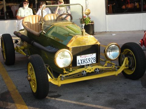 1998 Ford Crown Victoria - This vintage hot rod, likely from the 1910s, has a distinctive green and gold paint scheme.