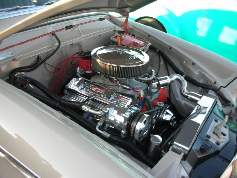 1998 Ford Crown Victoria - The engine bay of a car is shown with a polished V8 engine and various components.