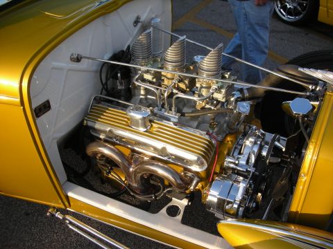 1998 Ford Crown Victoria - Close-up of a custom V8 engine triple carburetors and chrome components.
