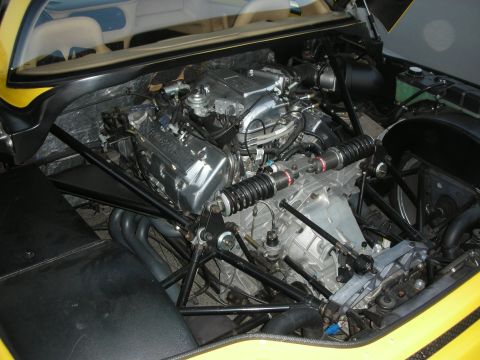 1998 Ford Crown Victoria - Detailed view of a V-engine in a yellow sports car's engine bay.