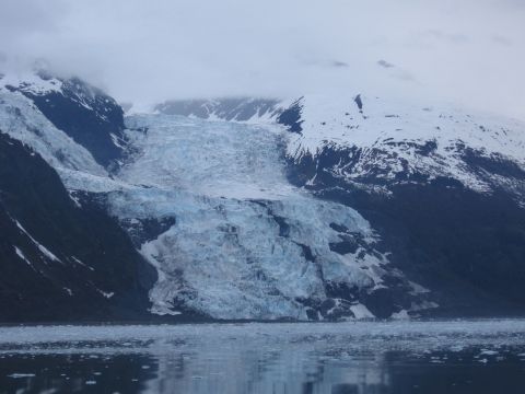 1973 Ford Ranchero - A vast glacier dominates the landscape, its blue ice contrasting with the dark mountains and white snow.