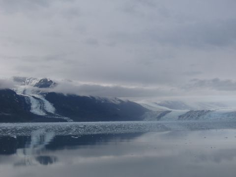 1973 Ford Ranchero - A vast glacier meets the water under a cloudy sky, with icebergs scattered across the surface.