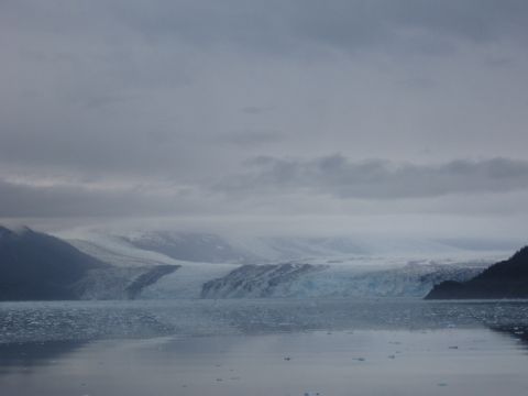 1973 Ford Ranchero - A vast glacier flows into the sea, surrounded by mountains and a misty atmosphere.