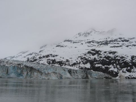 1973 Ford Ranchero - A vast glacier meets the water, with , snow-capped mountains rising behind it under an overcast sky.