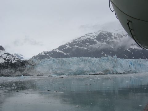 1973 Ford Ranchero - A large glacier face meets the water, with icebergs floating and mountains looming behind.