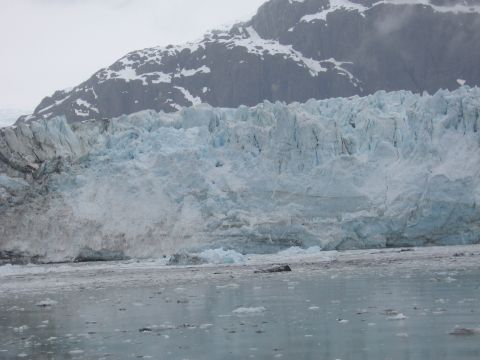 1973 Ford Ranchero - A vast glacier meets the water, with a snow-covered mountain looming behind.