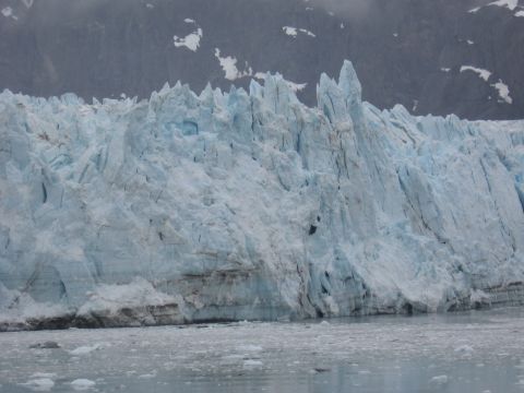 1973 Ford Ranchero - A massive glacier face with sharp ice peaks dominates the frame, with dark mountains visible behind it.