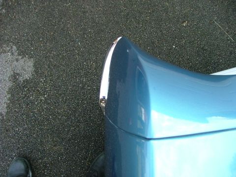 1970 Ford Ranchero - A close-up shot focuses on the curved fender and chrome accent of a blue vehicle.