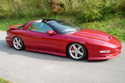 1993 Pontiac Firebird - Red 1993 Pontiac Firebird with aftermarket wheels and lowered suspension.