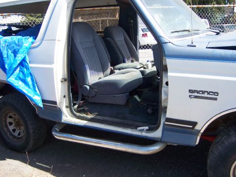 1991 Ford Bronco - The interior of a 1991 Ford Bronco, its front seats and door panel, is visible in this registry photo.