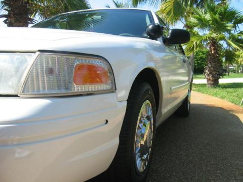 2001 Ford Crown Victoria - A white 2001 Ford Crown Victoria is shown from the front quarter angle, parked outdoors.
