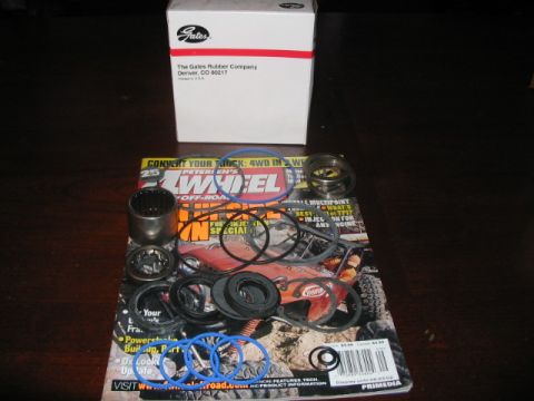 1991 Ford Bronco - Various automotive seals and bearings are displayed on top of a 4-Wheel & Off-Road magazine.