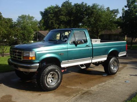 1996 Ford F-150 - This lifted 1995 Ford F-150 pickup truck is shown in a three-quarter front view.