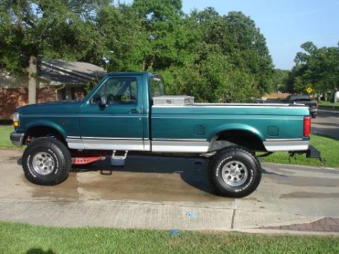 1996 Ford F-150 - This lifted 1996 Ford F-150 pickup truck is shown in a side profile, off-road tires and a toolbox in the bed.