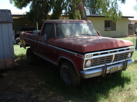 1977 Ford F-150 - This 1977 Ford F-150 pickup truck is parked outside a building.